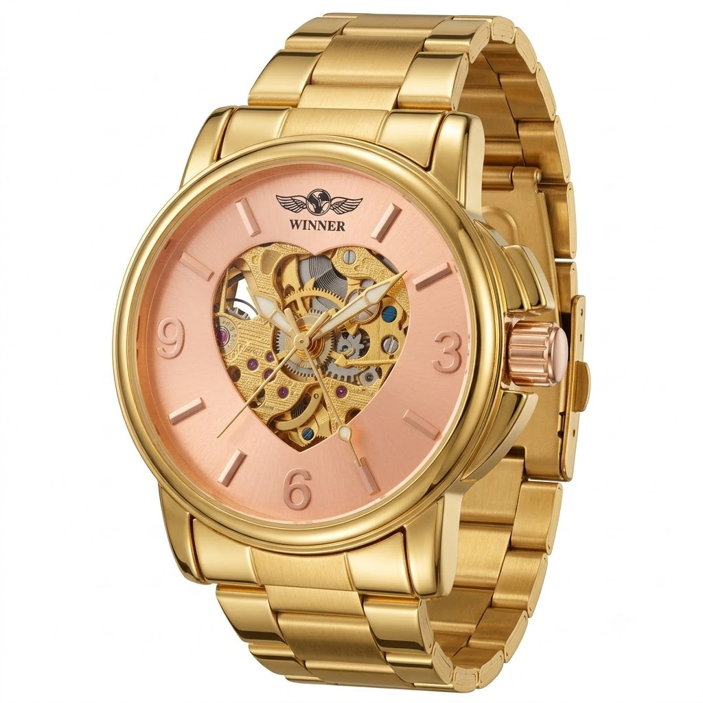 A gold-tone stainless steel automatic watch with a rose gold dial and a heart-shaped skeleton dial showing the inner mechanical movement. The brand name 'WINNER' is printed above the heart dial.
