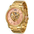 A gold-tone stainless steel automatic watch with a rose gold dial and a heart-shaped skeleton dial showing the inner mechanical movement. The brand name 'WINNER' is printed above the heart dial.