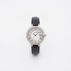 A Labiolo watch with a silver-tone round case, diamond-encrusted bezel, white dial with black Roman numerals, blue hands, and a black leather strap, centered on a plain white background.