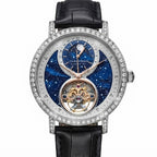 A luxury wristwatch by Lange & Söhne, featuring a silver-tone case encrusted with clear stones, a black leather strap, and a detailed blue galaxy-patterned dial with a visible gold-toned tourbillon.