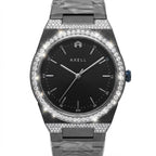 Axell watch with a black dial, black ceramic bracelet, and a bezel and case accented with sparkling clear crystals, shown on a white background with decorative light flares.