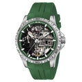 A luxury skeleton watch by ALIX with a green silicone strap, a silver stainless steel case, and a detailed skeleton dial showing a mechanical movement and a figure.
