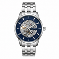 A silver stainless steel automatic watch with a blue skeleton dial, showing the inner mechanical movement. The brand name 'ORIV' is visible on the dial.