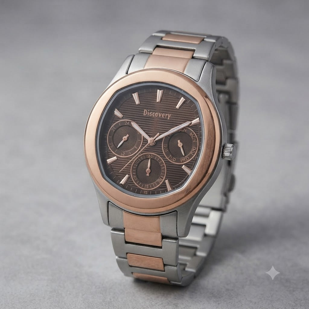 A high-resolution professional studio photograph of a two-tone men's chronograph watch from Discovery, presented against a neutral grey textured background. The watch features a silver stainless steel case and bracelet, accented by a prominent rose gold-tone bezel. The brown dial is textured with a subtle horizontal stripe pattern and displays three rose gold-rimmed sub-dials for chronograph functions. The 'Discovery' logo is positioned below the 12 o'clock marker, and the applied hour markers and hands are