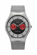 A Bering men's watch featuring a silver-tone mesh strap, a bezel encrusted with clear rhinestones, and a black carbon-fiber dial with two prominent red subdials.