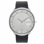 A luxury watch by M.TITAN, featuring a round silver-tone case encrusted with clear crystals, a silver-toned textured dial with a circular day/date window, and a black leather strap.
