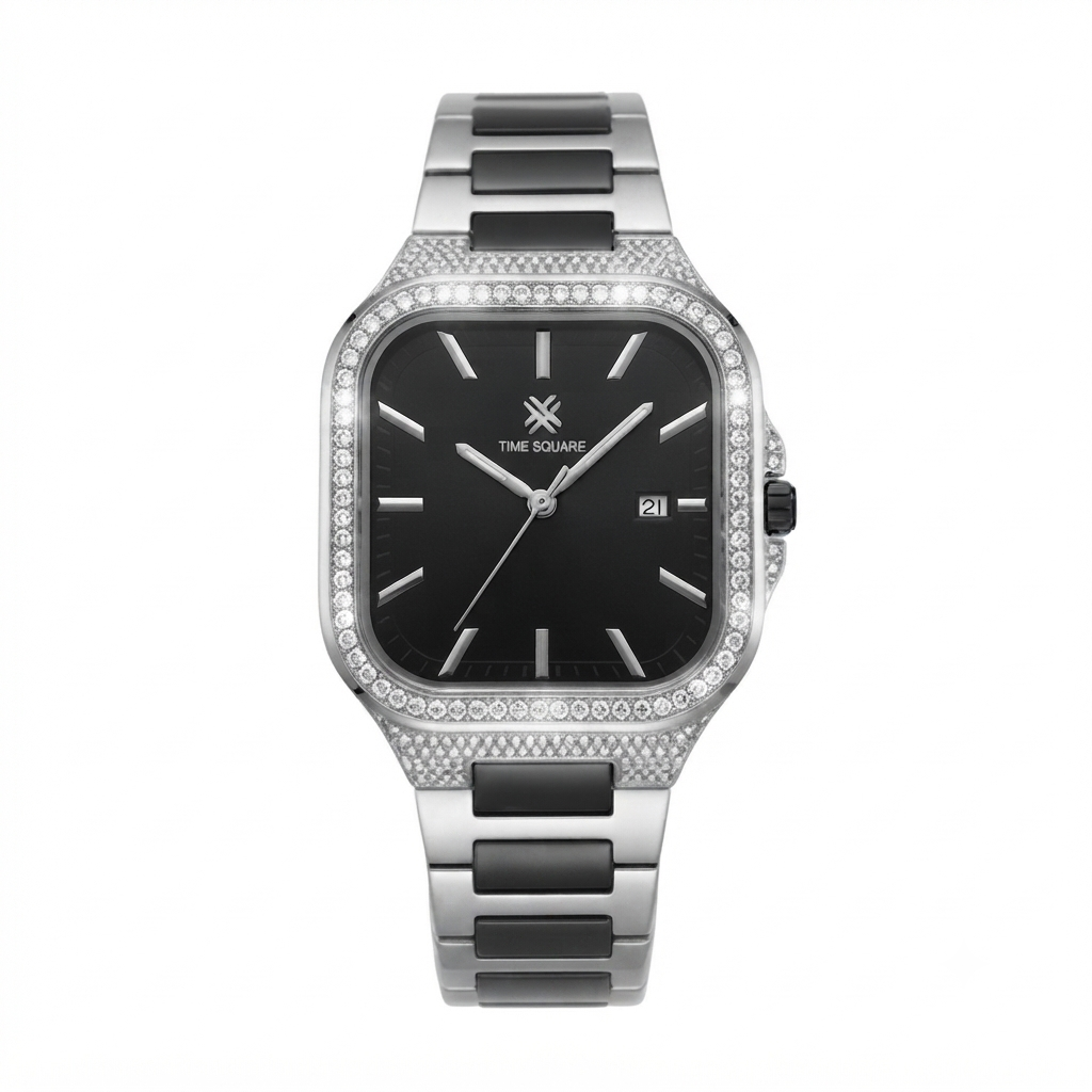 A square analog watch with a black dial, silver-tone case, and a bezel set with small clear stones. The integrated metal link band features alternating polished silver and matte black segments.