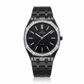 A black Arvari watch with a black dial, black link bracelet, and a bezel encrusted with clear stones, shown on a white background.