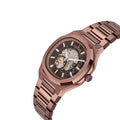 A rose gold-tone skeleton watch with a matching metal link bracelet, featuring a detailed mechanical movement visible through the dark brown dial on a white background.