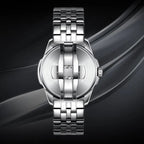 Silver stainless steel wristwatch with a multi-link bracelet and brushed metal case, shown from the back on a dark abstract background.