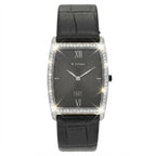A rectangular analog watch with a black textured dial, Roman numeral hour markers, silver-tone hands, and a bezel set with sparkling clear stones. It features a black leather strap with an alligator pattern, shown against a plain white background with digital starburst effects highlighting the crystal details.
