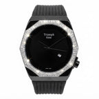 A black Triumph Time watch with a black dial, black ribbed strap, and a bezel encrusted with clear crystals, shown on a white background.