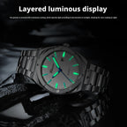 A stainless steel wristwatch with a luminous gray dial and green glowing markers, displayed on a dark reflective surface with promotional text at the top.