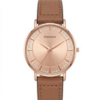 A men's analog watch with a round rose gold case, a matching rose gold dial featuring crystal hour markers, and a brown leather strap, shown on a plain white background.