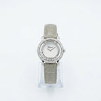 A Chapsel women's watch featuring a silver-tone oval case with a halo of clear crystals, a silver sunburst dial, and a light gray alligator leather strap, displayed on a clear stand against a white background.