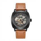 A men's skeleton watch with a black case, brown leather strap, and a transparent dial showing the inner mechanical movement, on a solid white background.